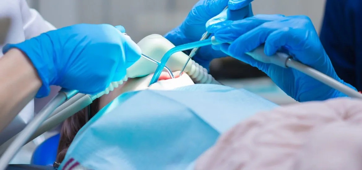 Little girl getting Inhalation Sedation while undergoing a dental treatment