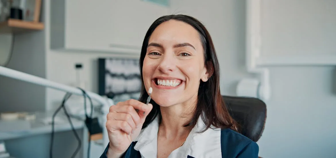smiling woman sitting in a dental chair, dental implants